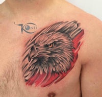 an eagle tattoo on the chest of a man