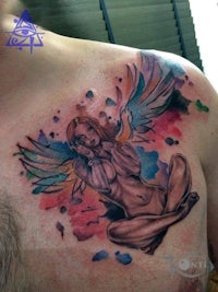 a man with an angel tattoo on his chest